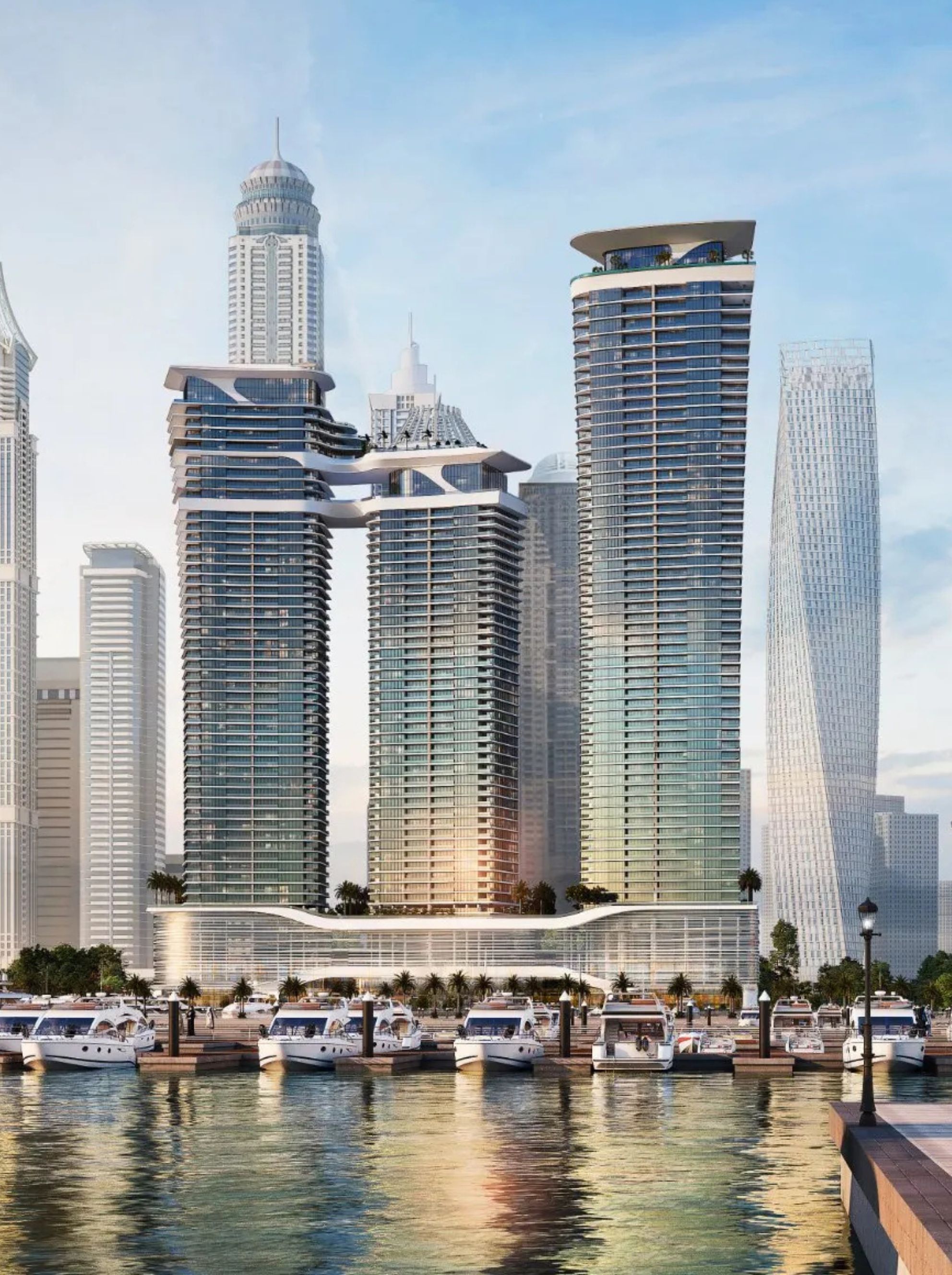 Modern waterfront skyscrapers with interconnected sky bridges and docked yachts reflecting in the water.
