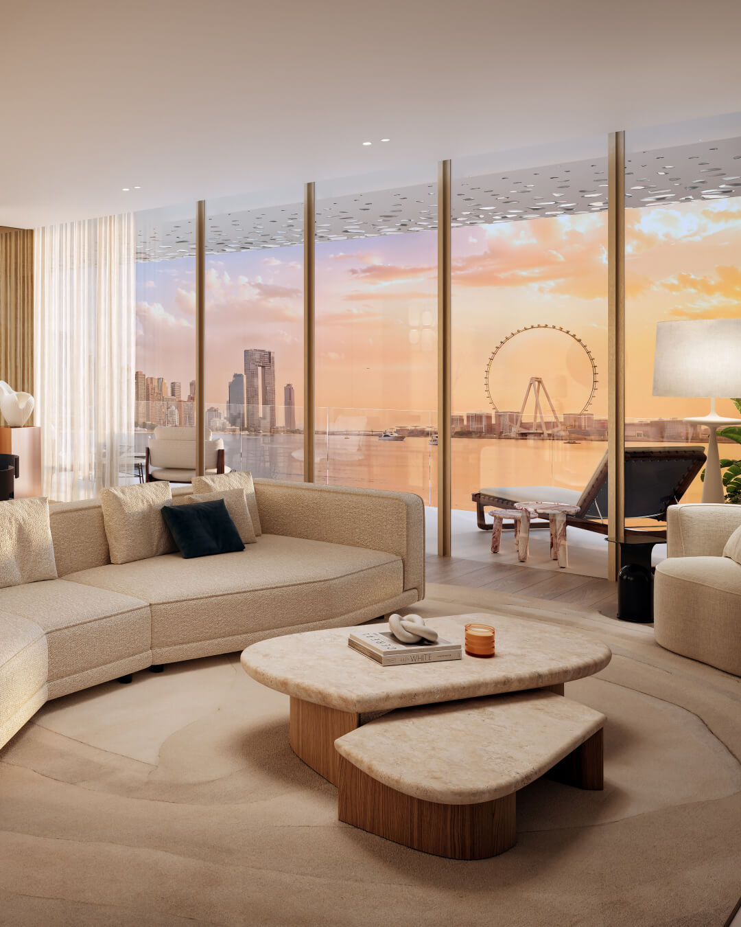 Modern living room with beige sectional sofa, marble coffee tables, and floor-to-ceiling windows overlooking a waterfront cityscape and a large Ferris wheel at sunset.