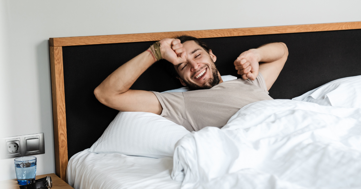 Man waking up in bed with no morning wood and wondering whether it could mean low testosterone or ED