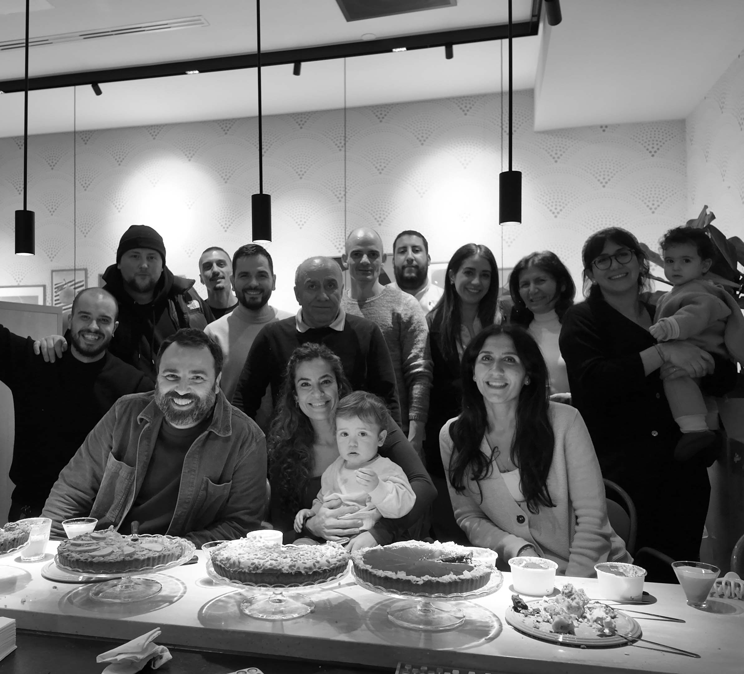 Two guys busy in the kitchen preparing pizza