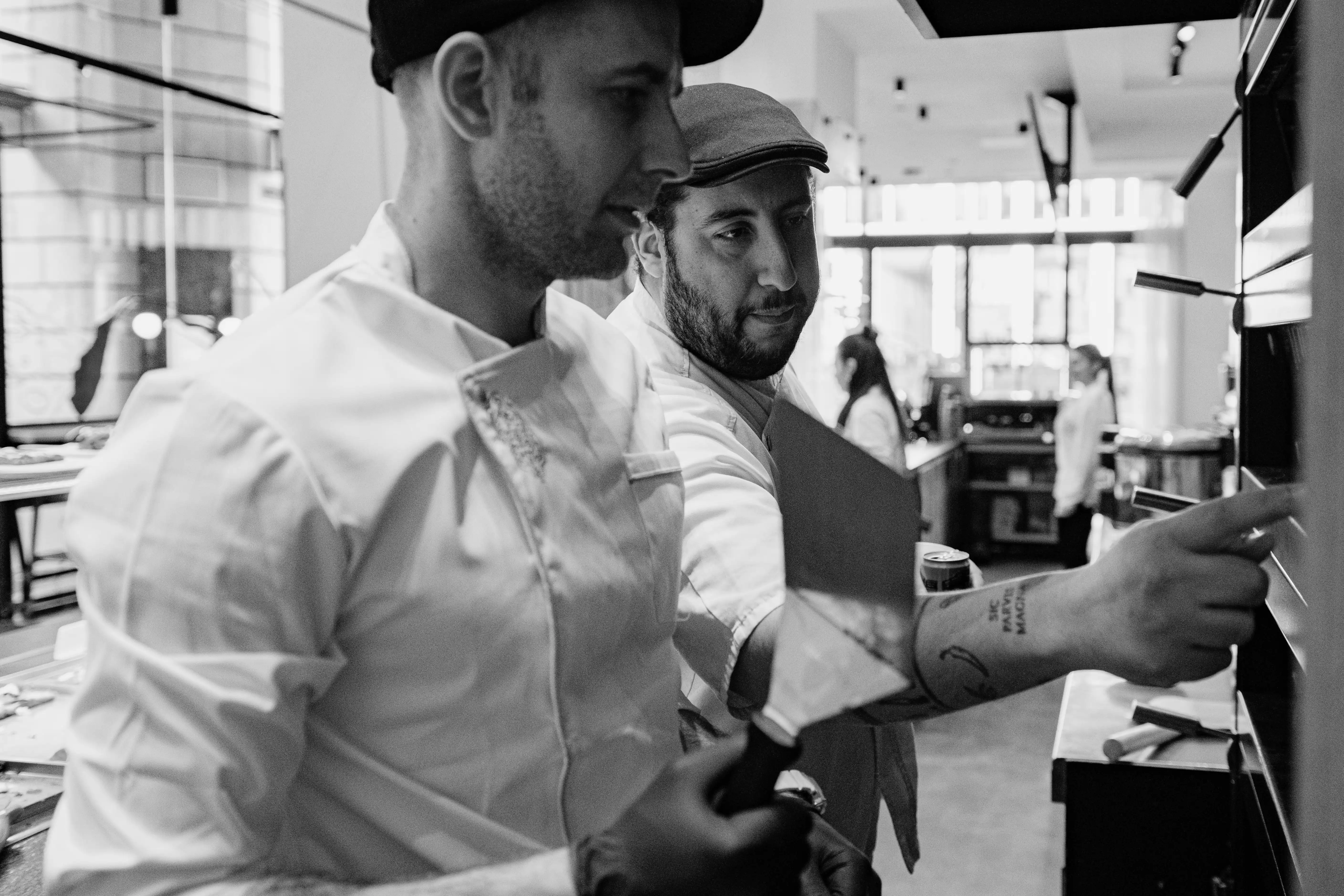 Chef placing cheese on raw pizza bread