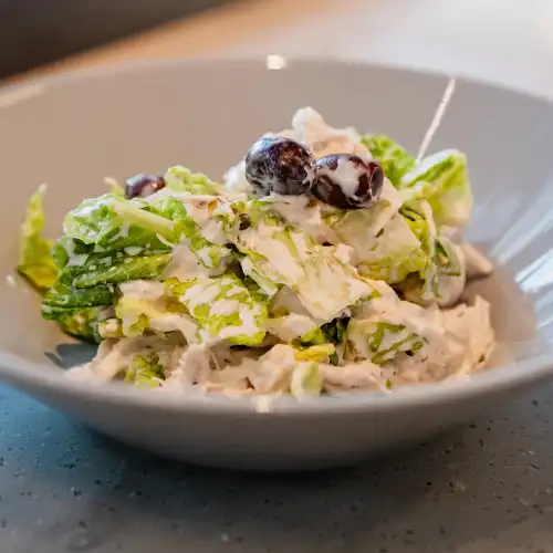 Italian style pizza with fresh cheese, herb, and small colourful tomatoes