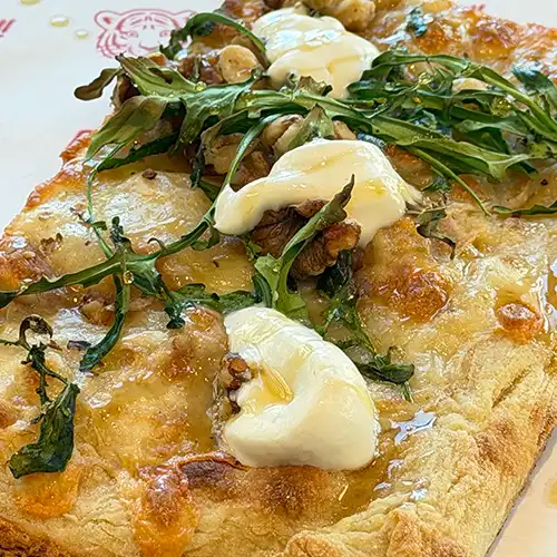 Italian style pizza with fresh cheese, herb, and small colourful tomatoes