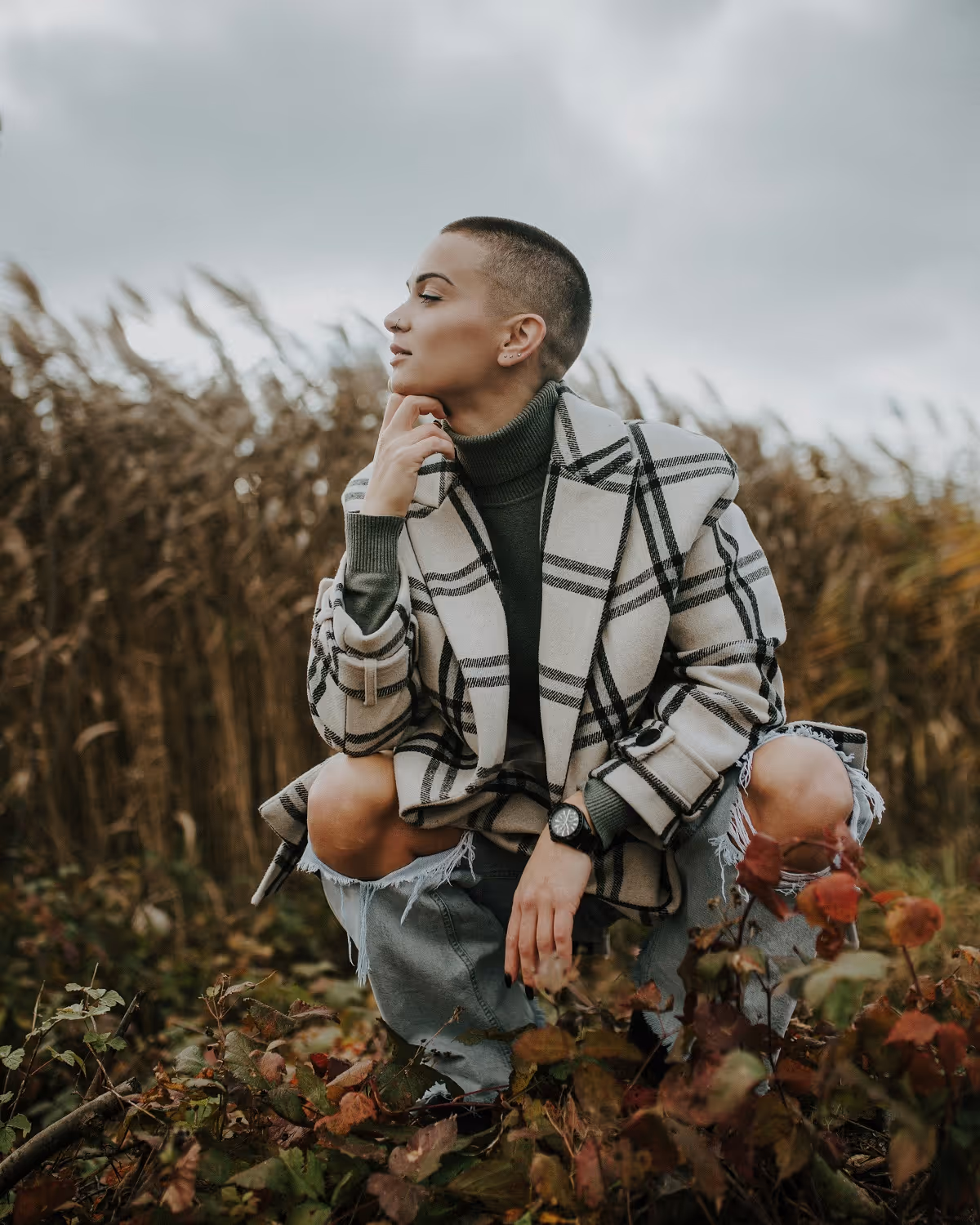Woman sitting in field of grass