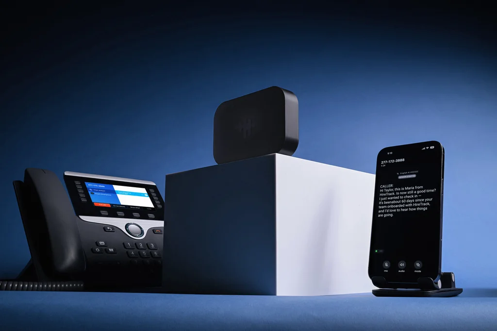 Bridge device with a desk phone and smartphone displaying real-time call captions