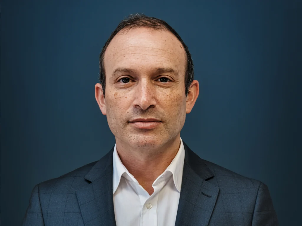 David Landesman, Chief Operating Officer, a man with short dark hair in a grey blazer and white shirt
