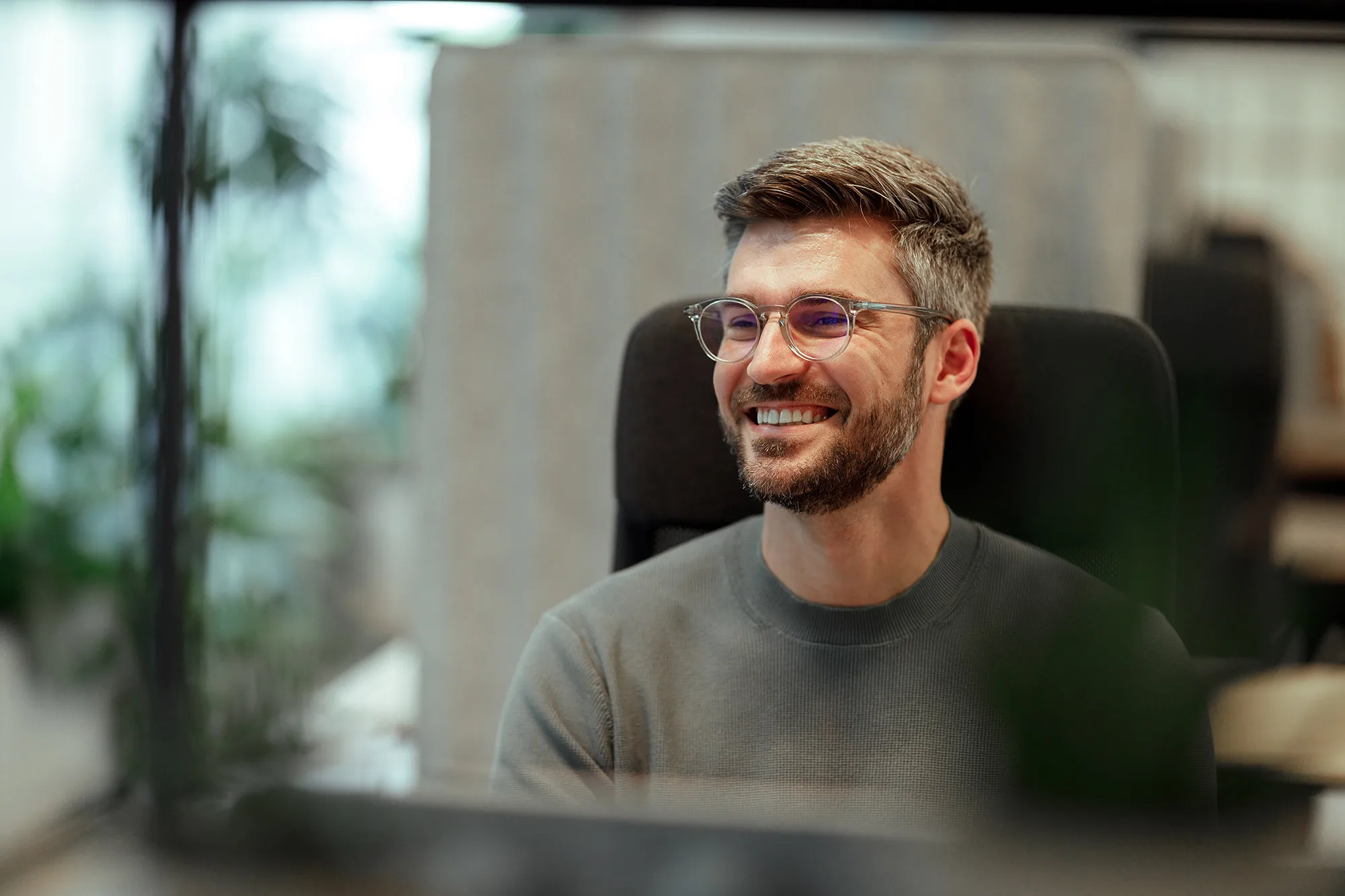 Smiling man sitting at a desk
