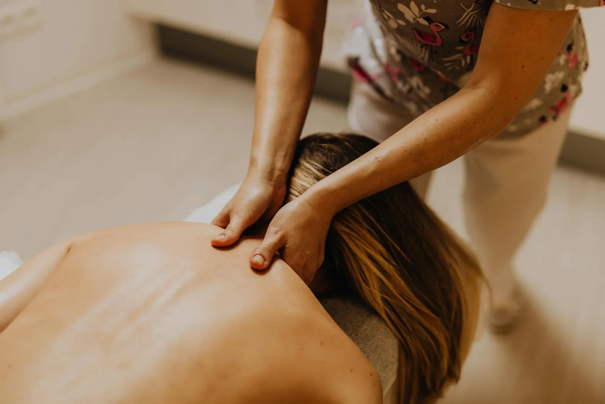 Esthetician giving a relaxing shoulder massage at Elite Skin and Body MD