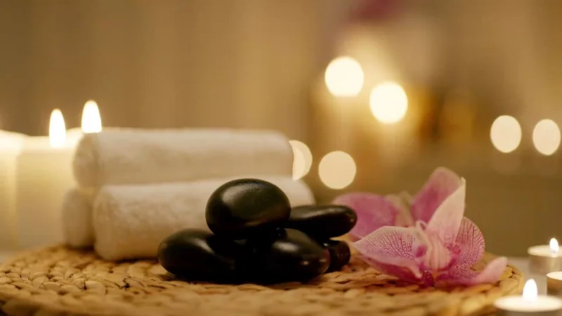 Warm stones, towels and candles in a treatment room