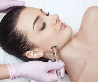 DiamondTome microdermabrasion wand on a cheek