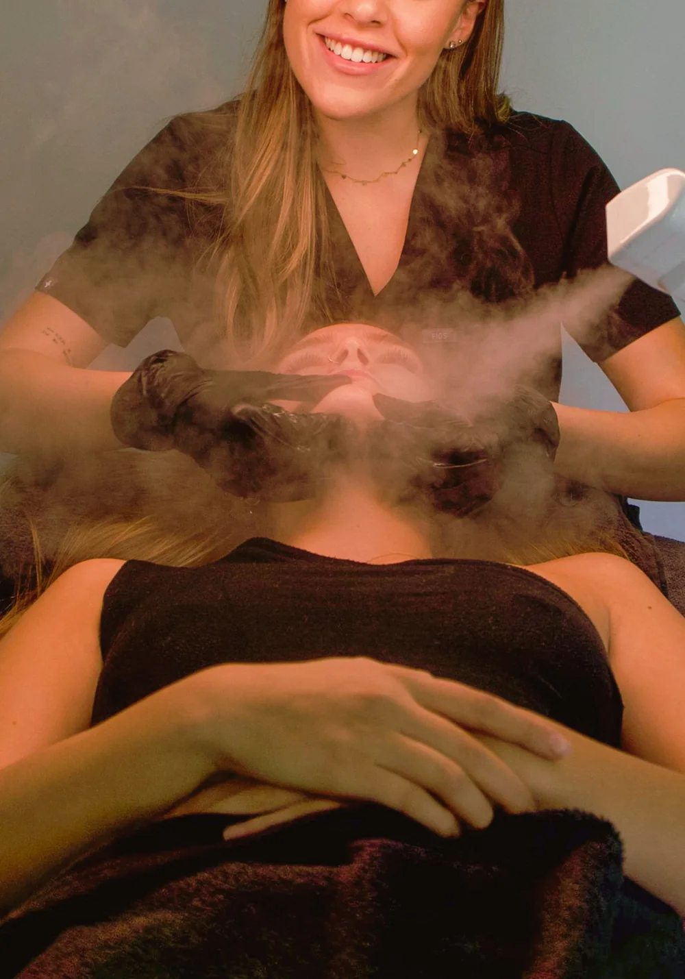 Esthetician giving a client a steam facial