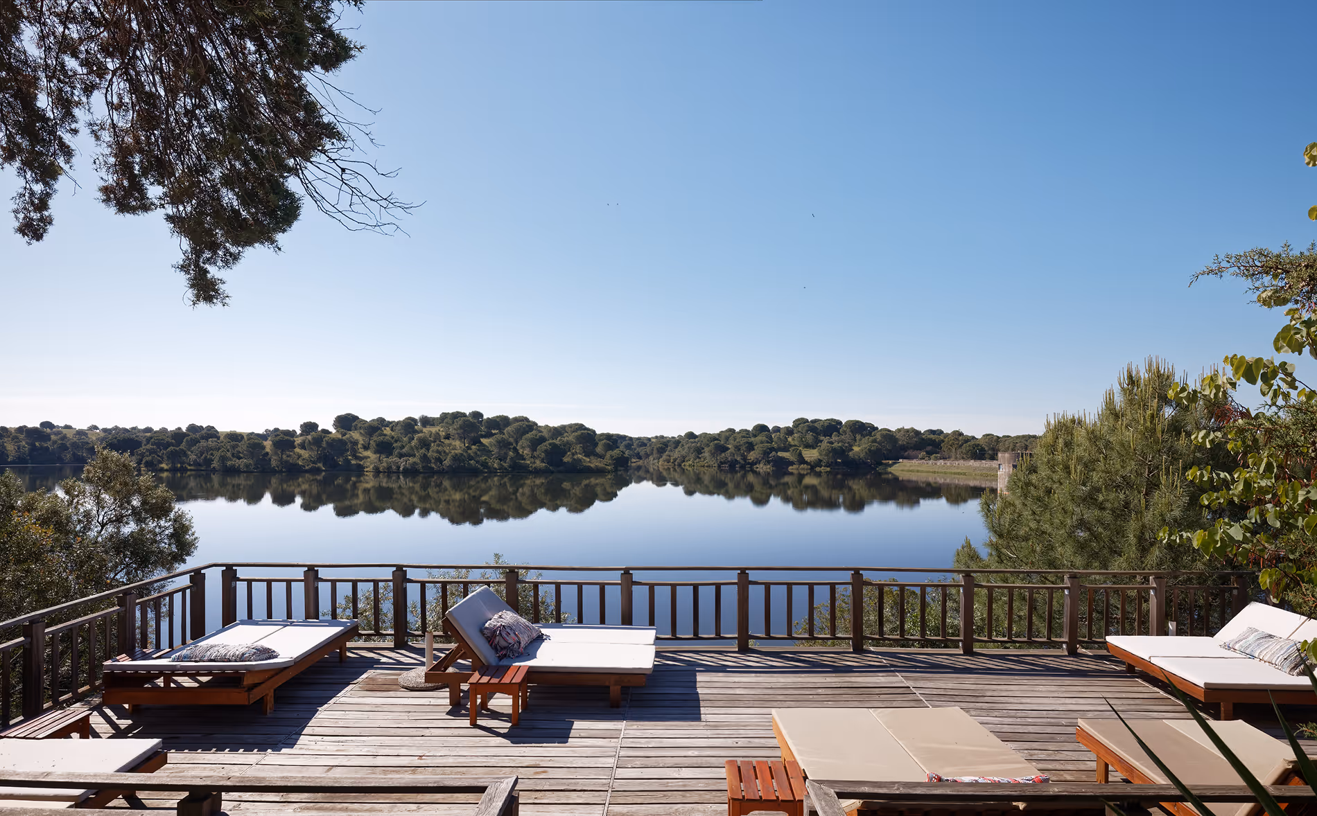Timber sun deck at Hotel Vale do Gaio with loungers facing the reservoir