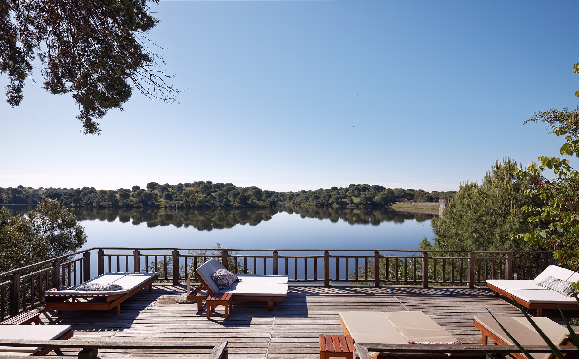 Timber sun deck at Hotel Vale do Gaio with loungers facing the reservoir