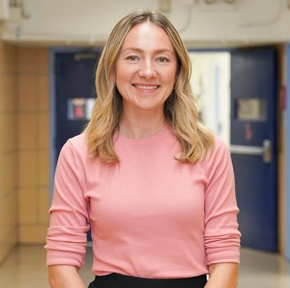 Yelena Shtyrkalo smiling in a school hallway