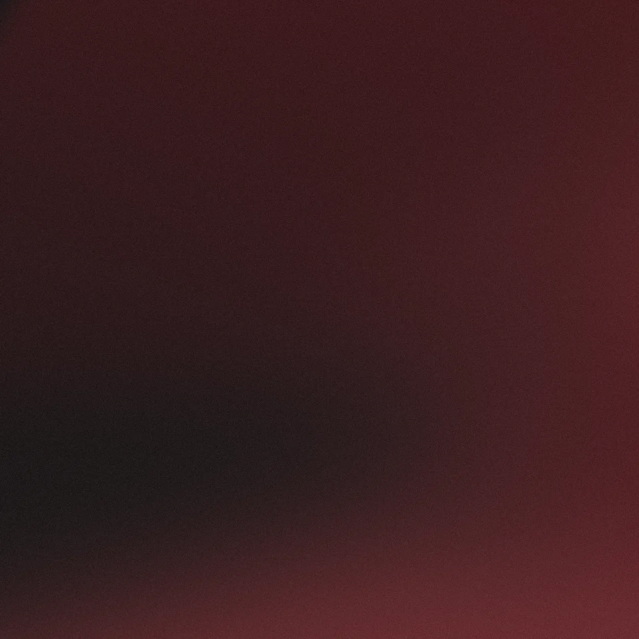 Verlaufshintergrund mit weichen Farbmischungen in Dunkelrot und Schwarz.