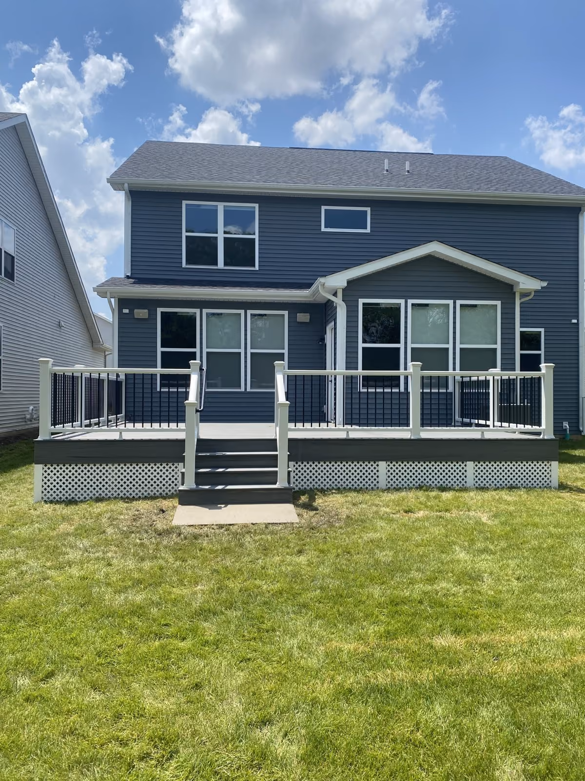 Rear deck and stairs on a blue-sided home