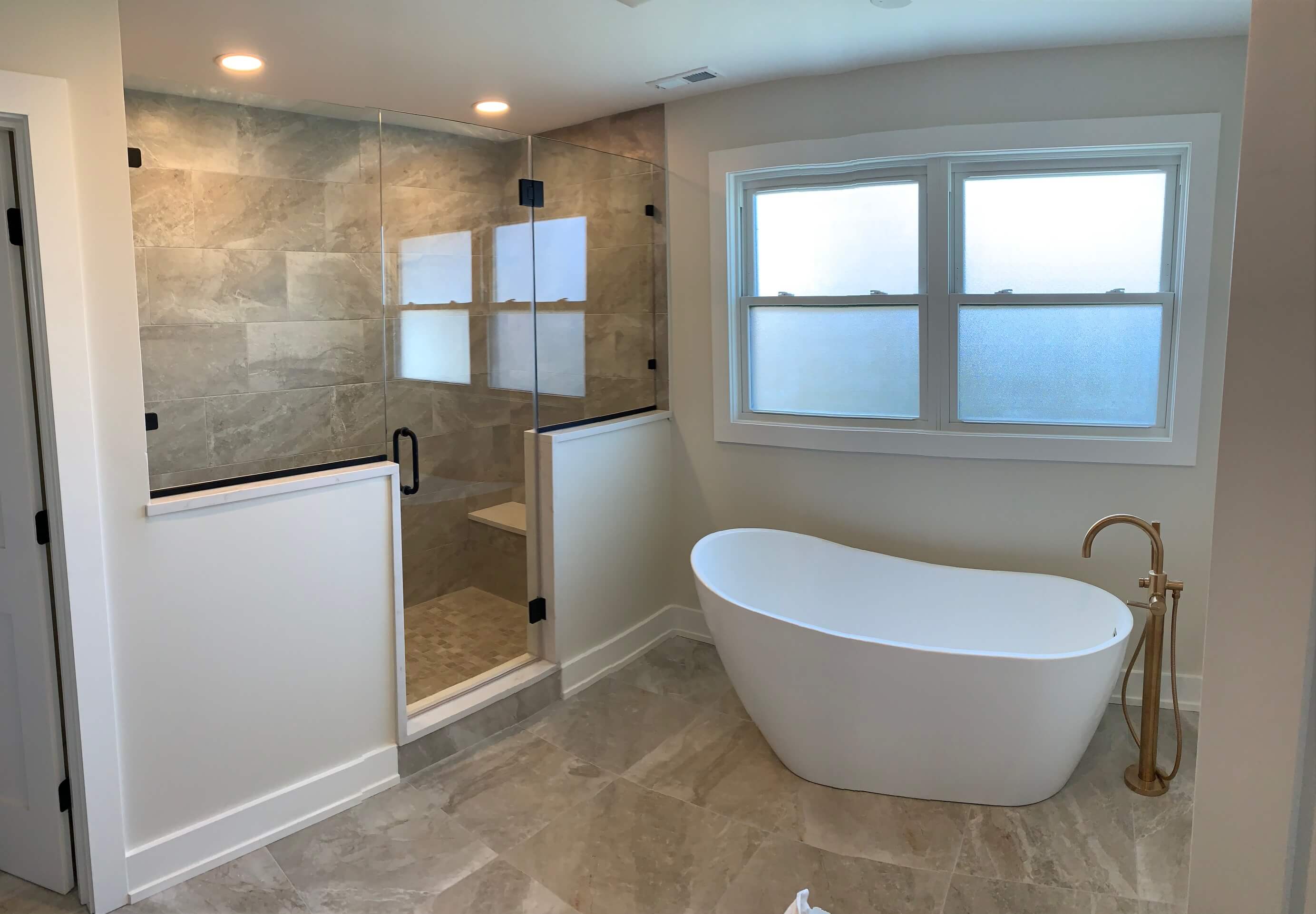 Backyard patio with a wooden pergola, ceiling fan, and built-in outdoor kitchen.