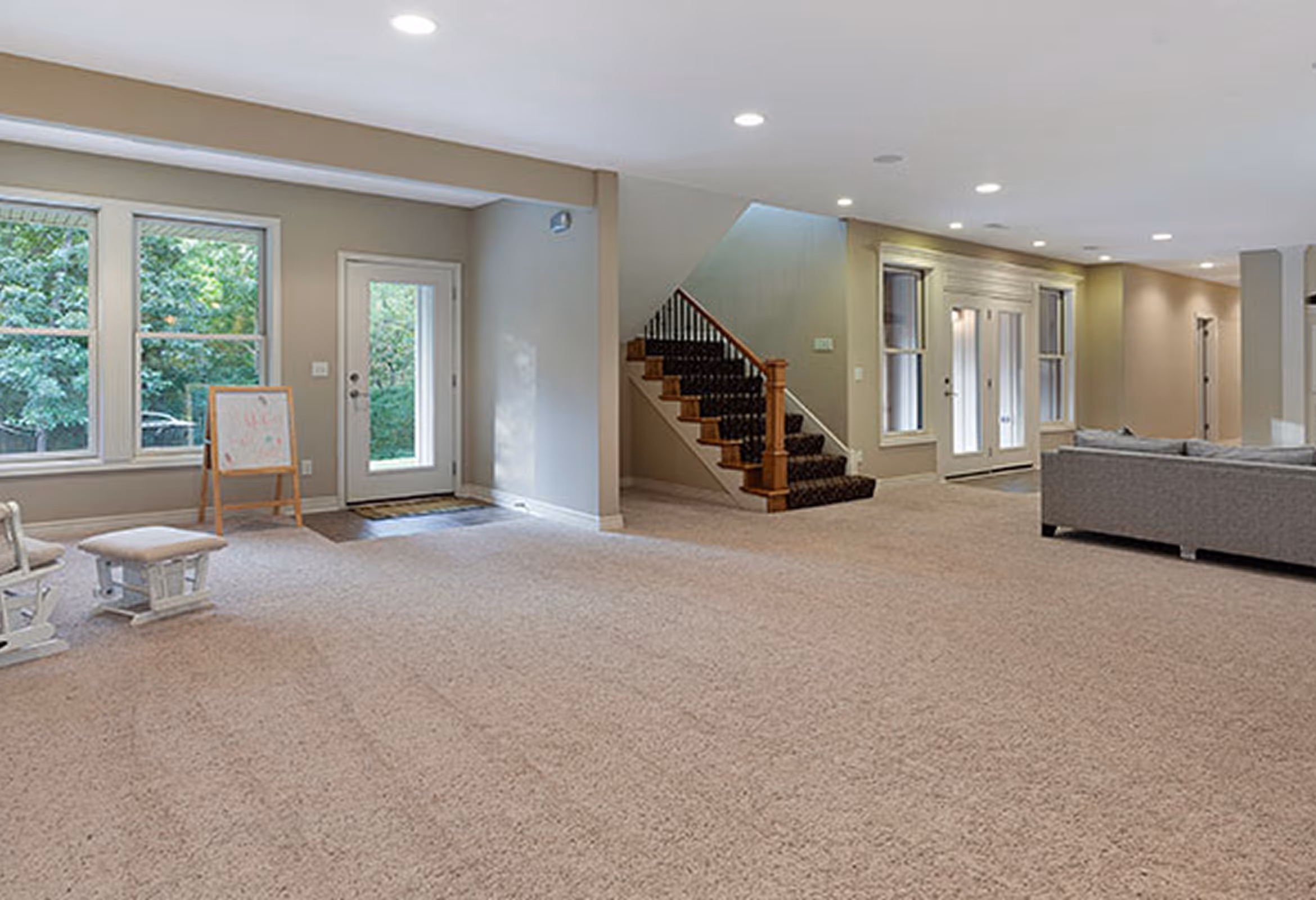 Basement remodeling Chicago suburbs - finished basement with staircase and carpet flooring