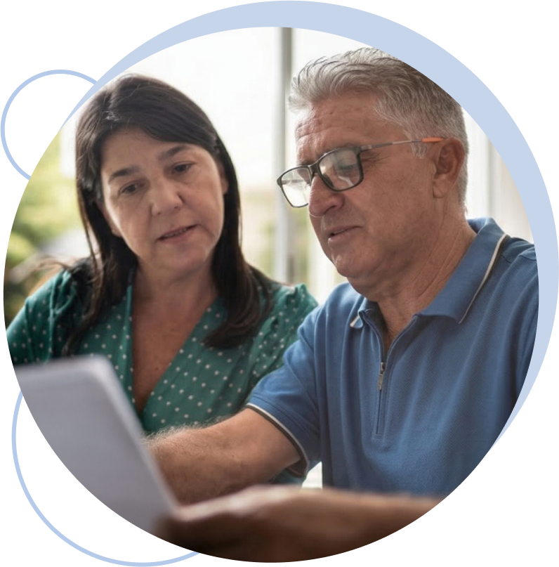 Couple reviewing Medicare & You Guide on a laptop