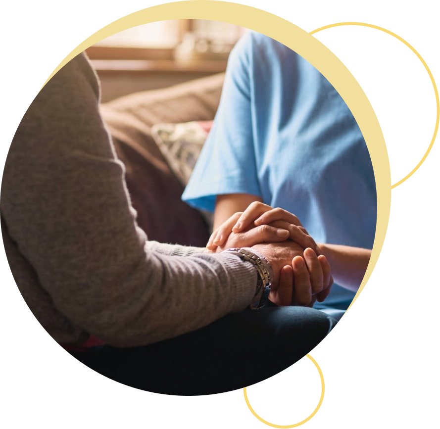 Care partner and healthcare worker holding hands