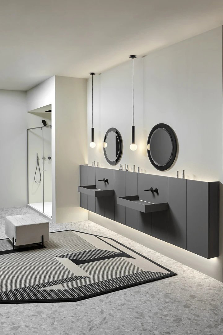 Bathroom with shower. Composition of double washbasin with cabinet, wall-mounted, colour grey, black taps. 2 round mirrors on the wall and lamps wall-mounted under a basin. Collection Showdown by Antonio Lupi.