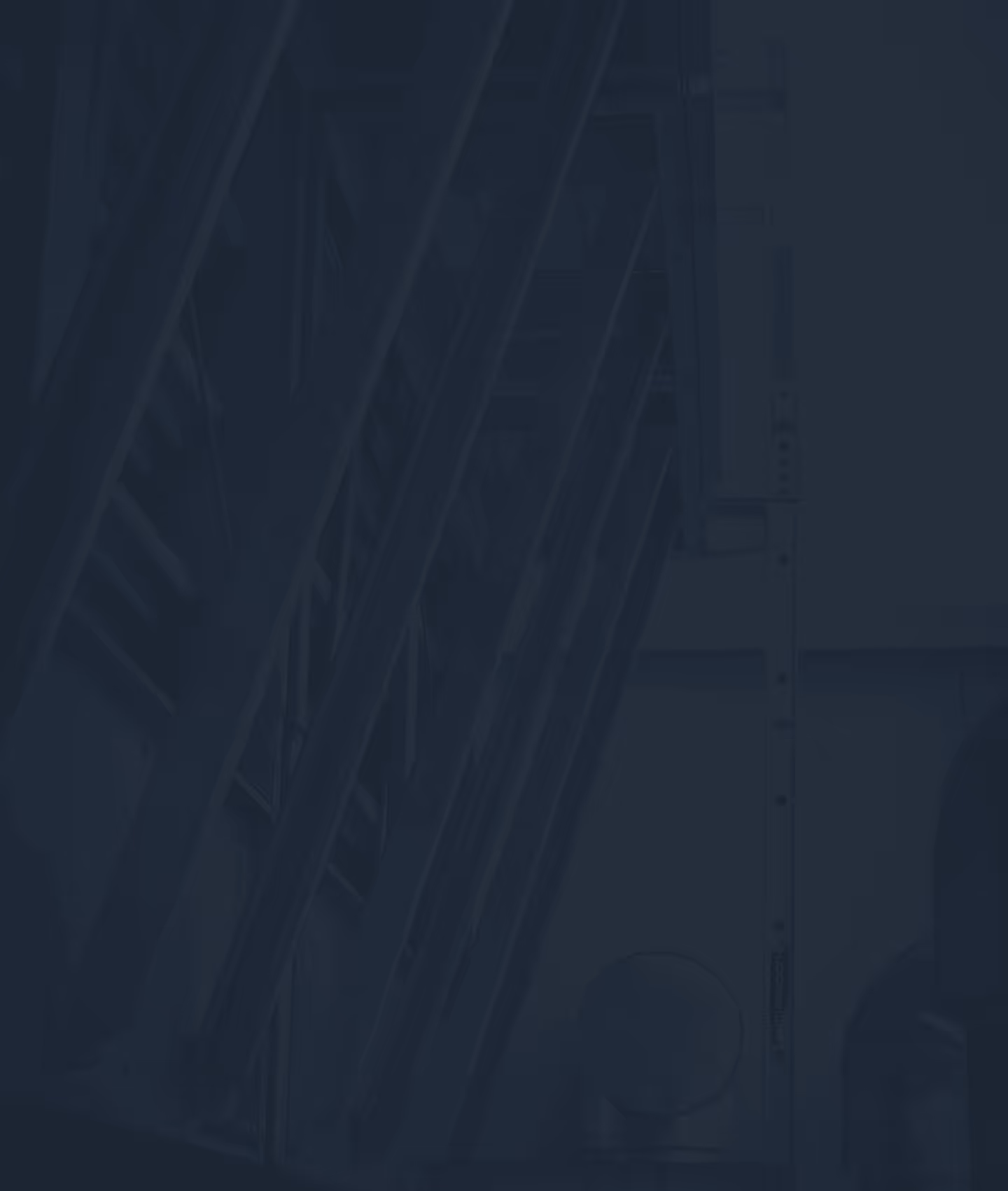 Dark blue tinted image of industrial metal structures with diagonal beams and round components.