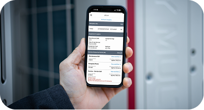 Hand holding phone displaying detailed financial transaction details in an app interface.