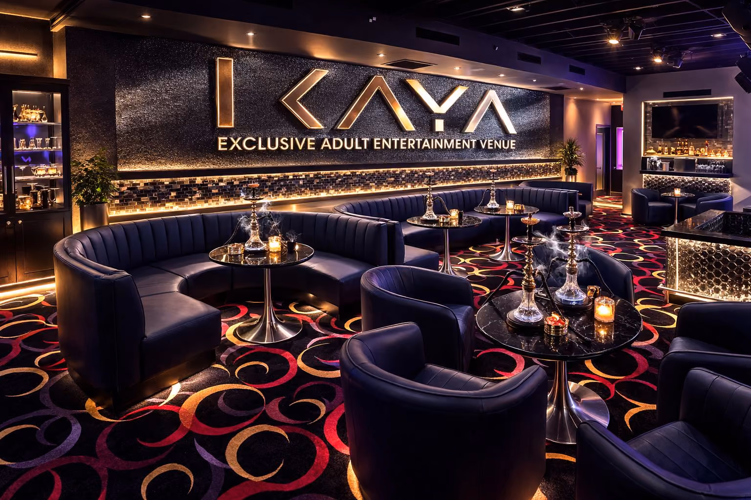 VIP tables and lounge seating in purple light below the KAYA sign