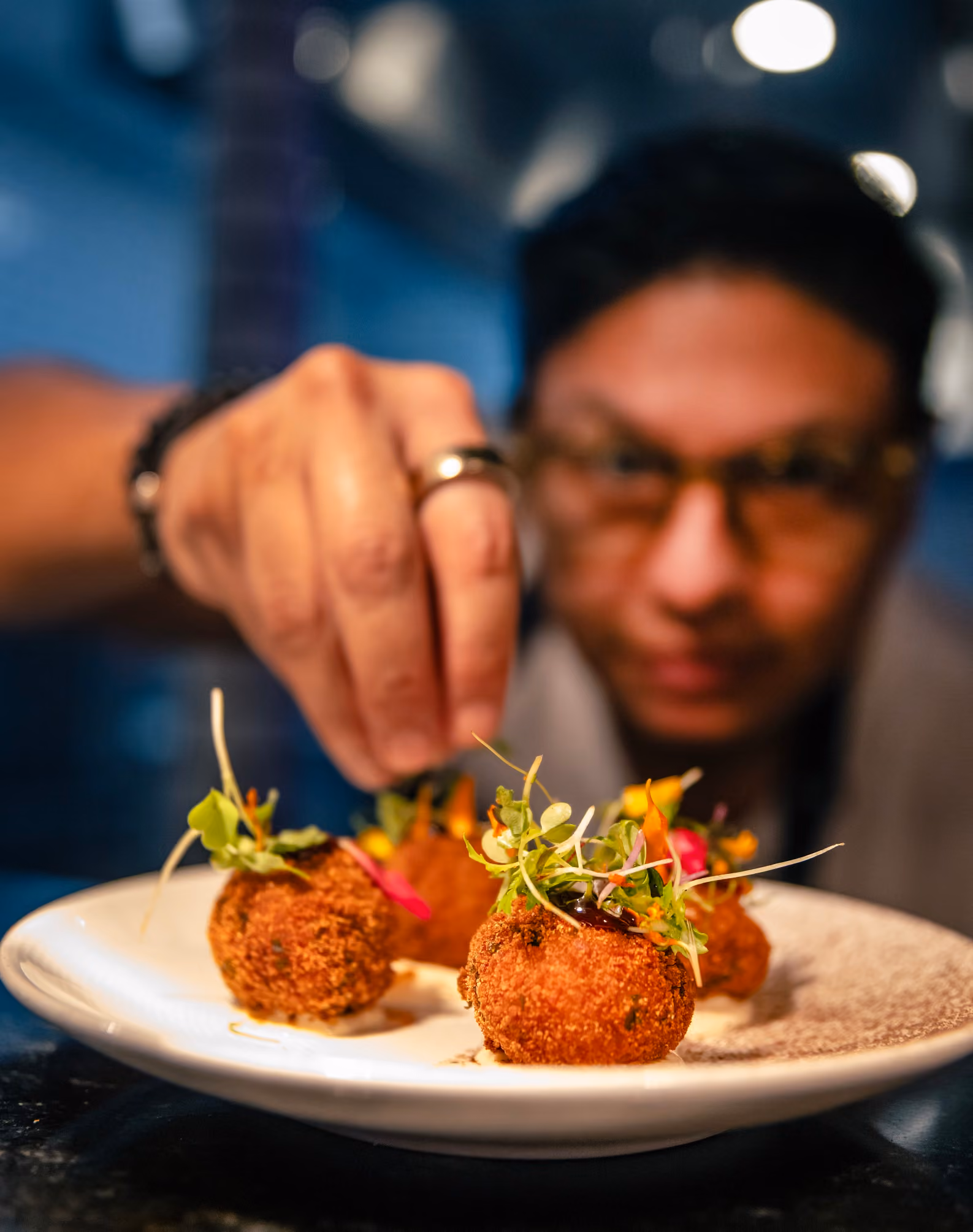 Chef plating a dish at KAYA Prime in Fort Lauderdale