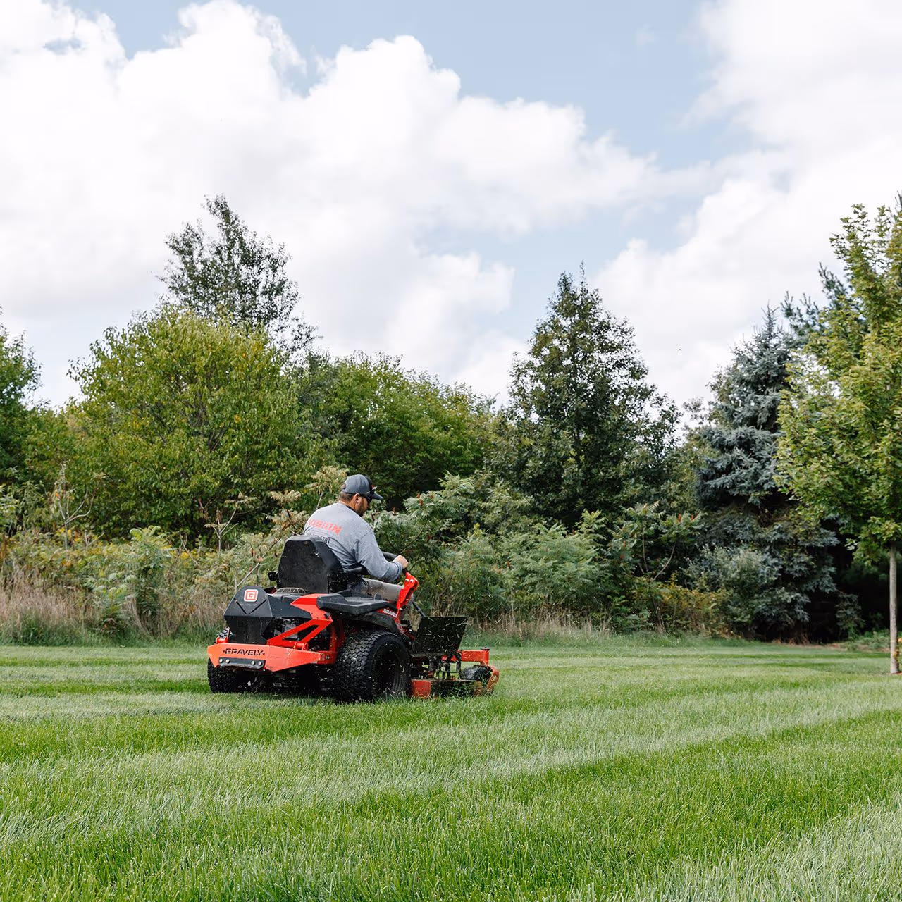 professional lawn care crew mowing and trimming in Baroda, Michigan by Vision Lawn and Property Management