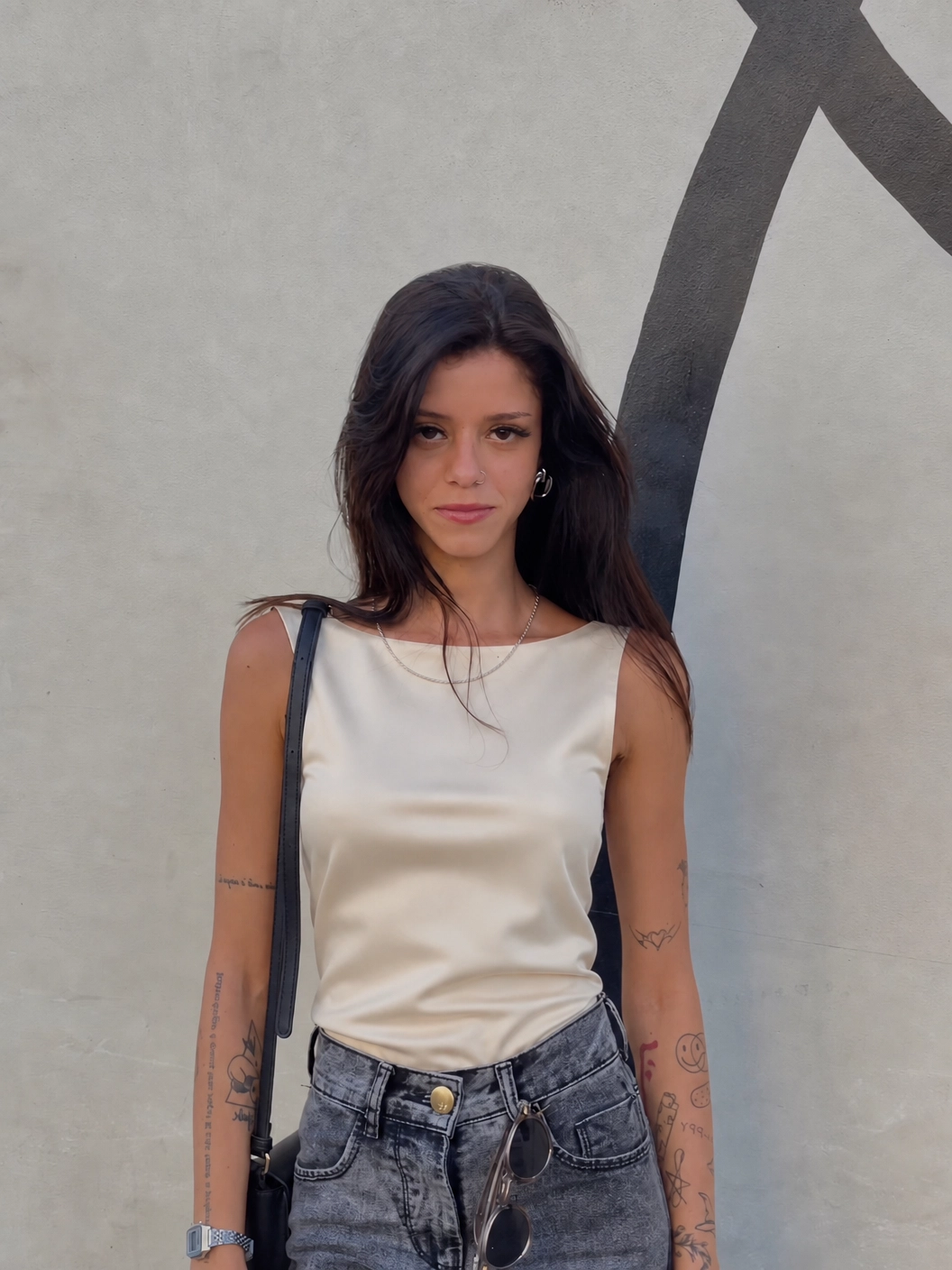 A woman in a white shirt and black pants.