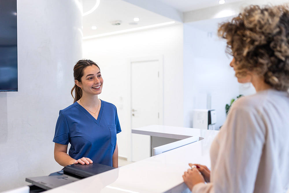 Organized front desk at a modern aesthetic clinic with calm patient check-in