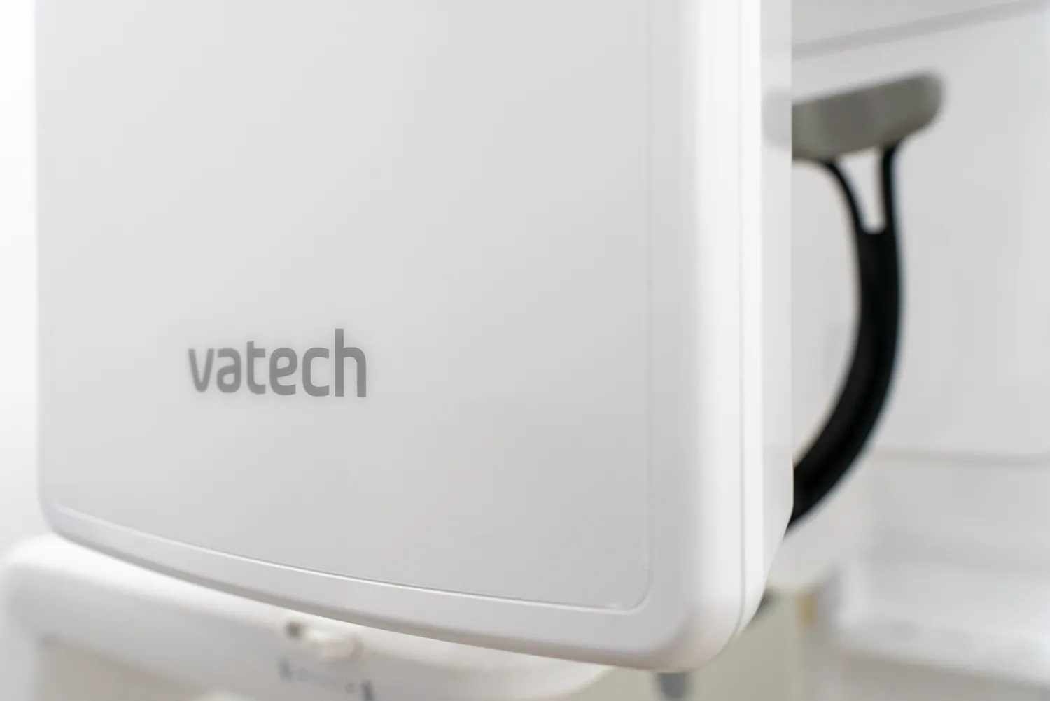 Close-up of a white medical device with the brand name vatech on its surface.