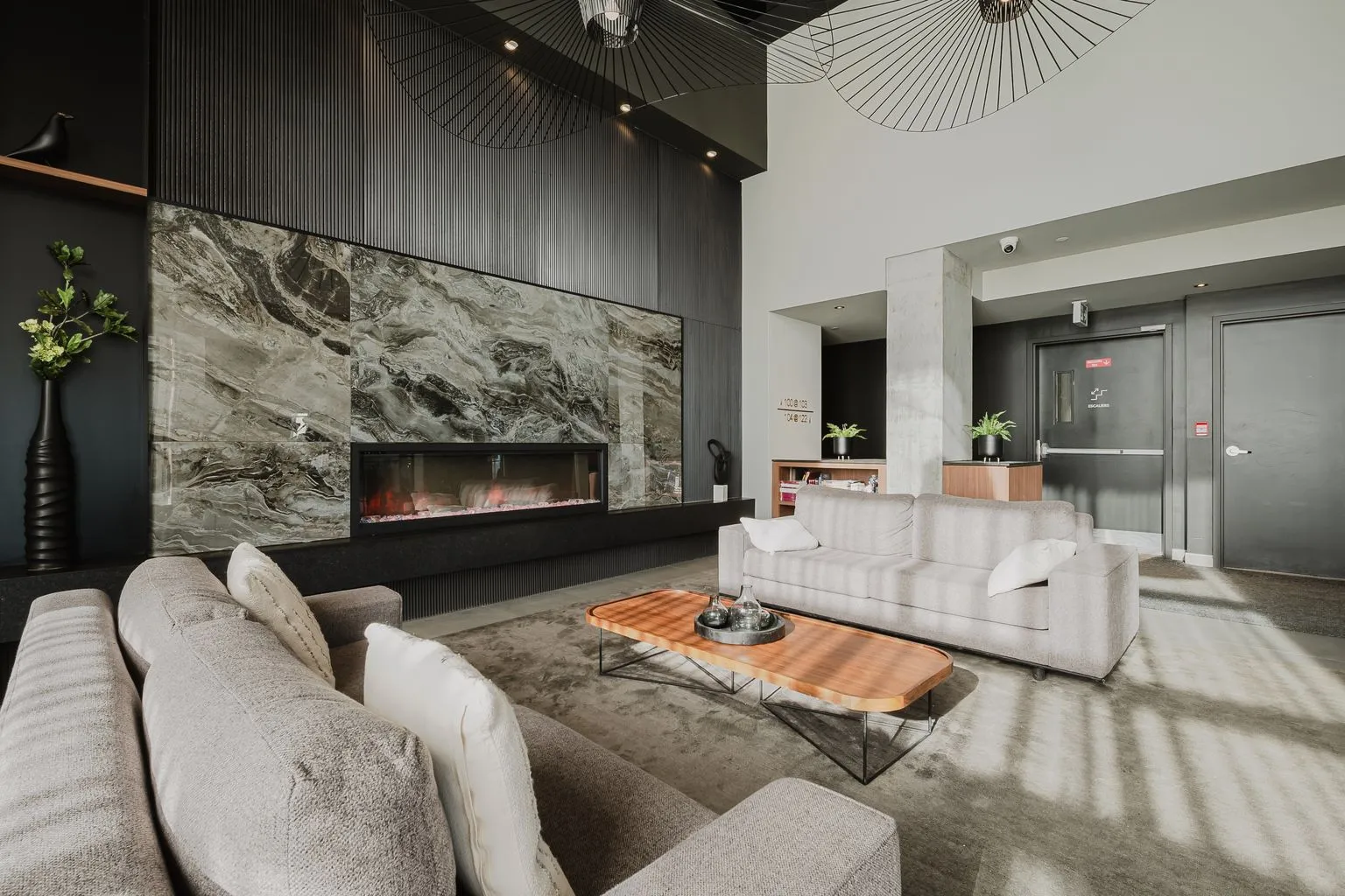 Lounge at Mostra Newman with fireplace, stone wall and large sofas