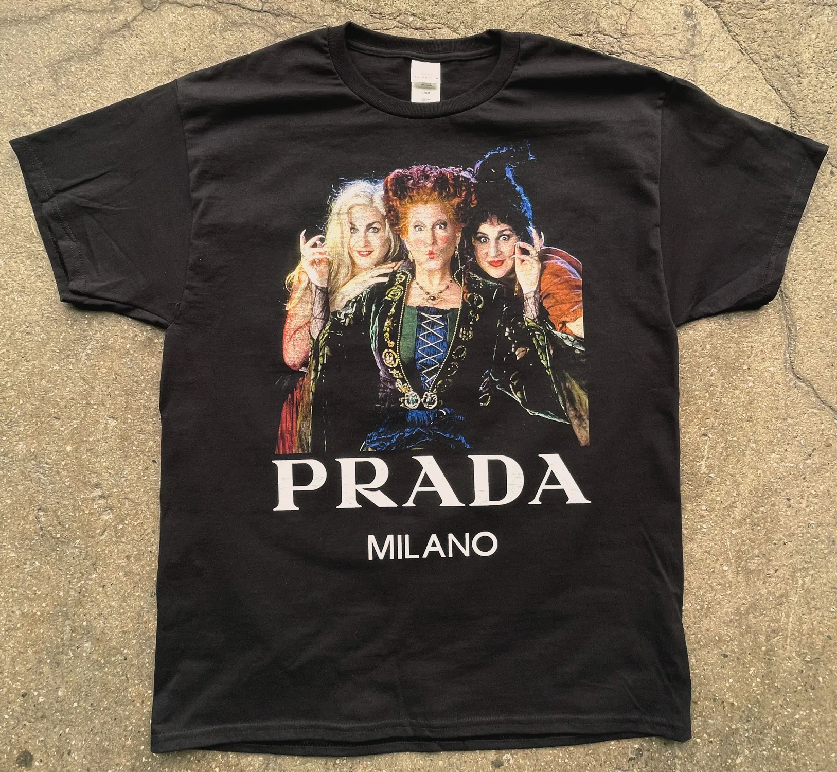 Black t-shirt featuring a graphic of three witches from the movie Hocus Pocus above the text 'PRADA MILANO.'