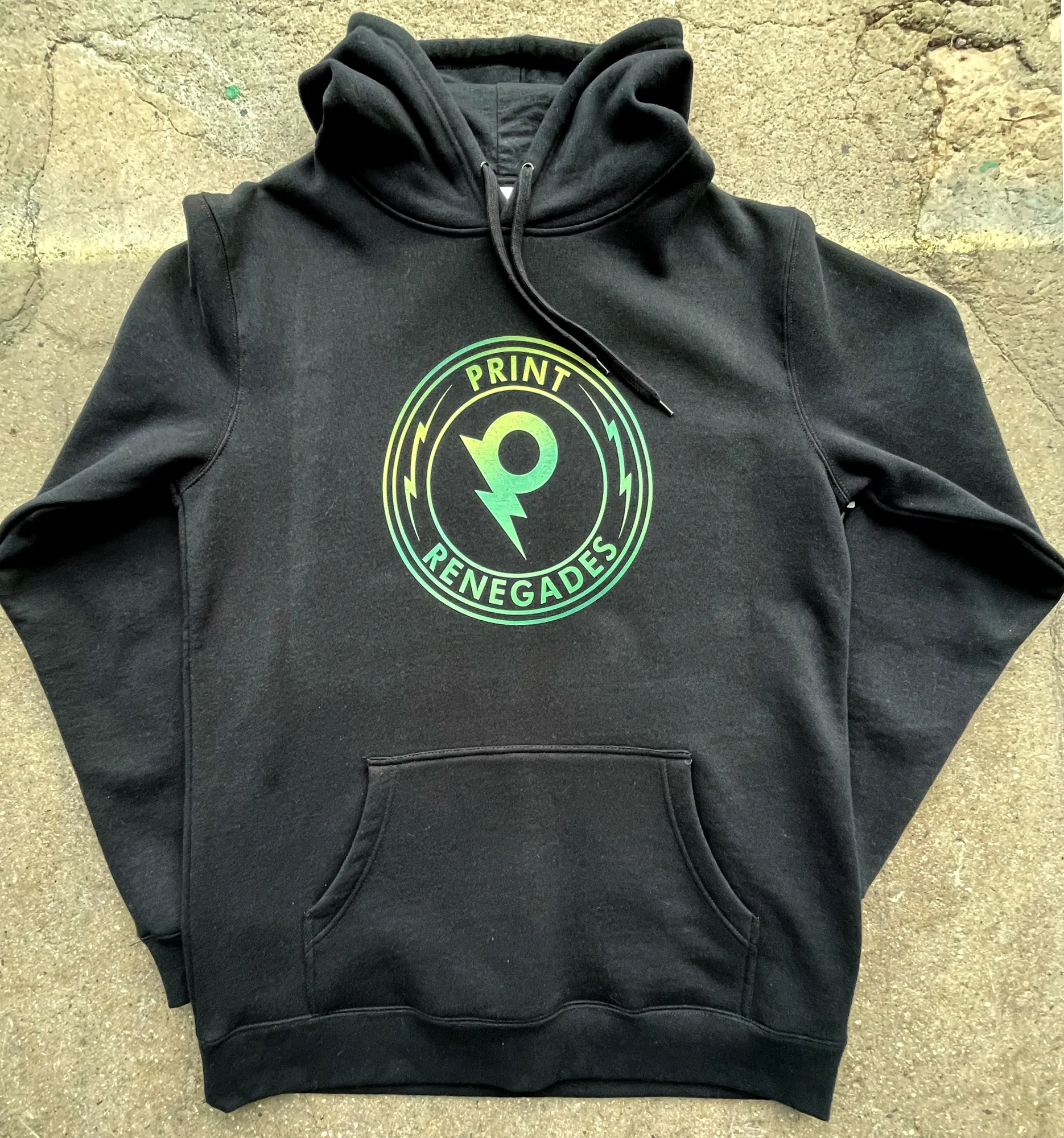 Black hoodie with a green and yellow circular 'Print Renegades' logo featuring a stylized letter P and lightning bolts.