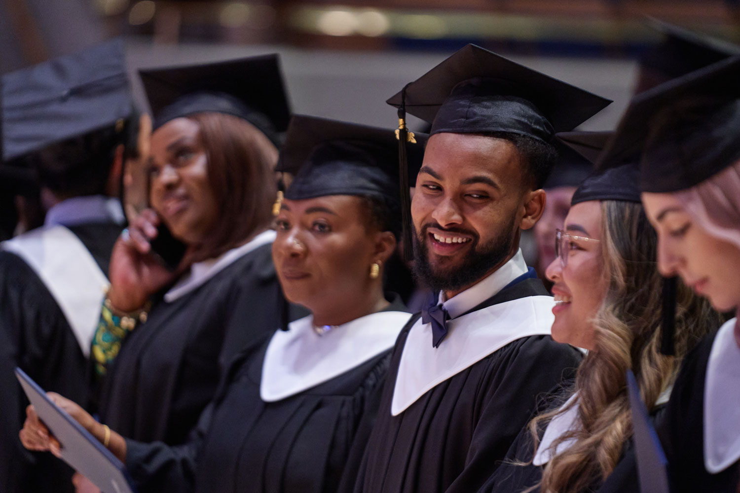 Standing Bow Valley College graduates smiling