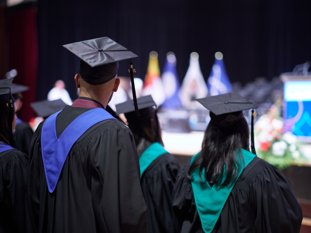 Bow Valley College graduates standing at Jack Singer Hall