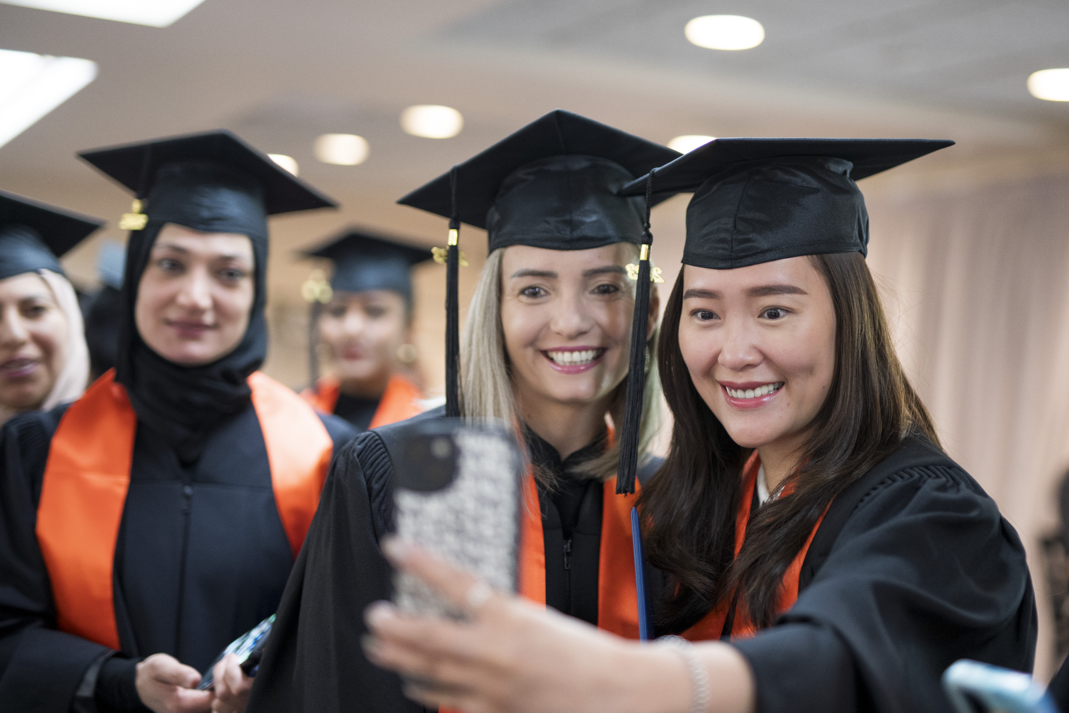 A couple of excited Bow Valley College graduates taking a selfie together