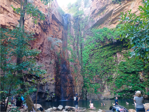 Watering Hole and waterfall in the Kimberley's with JSR students swimming in it.