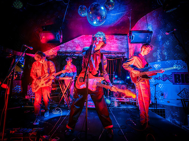 Live rock band performing on bright stage