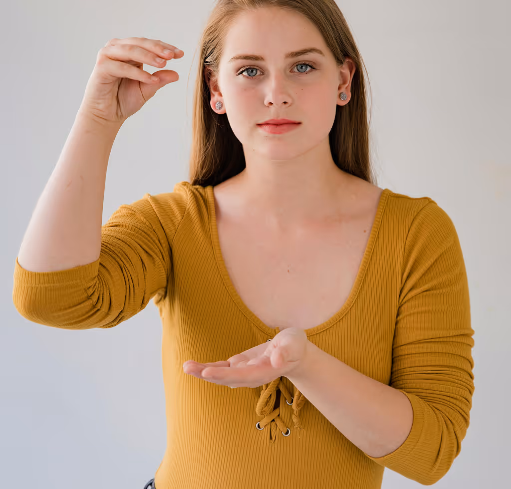 A woman is making a gesture - saying something in sign language