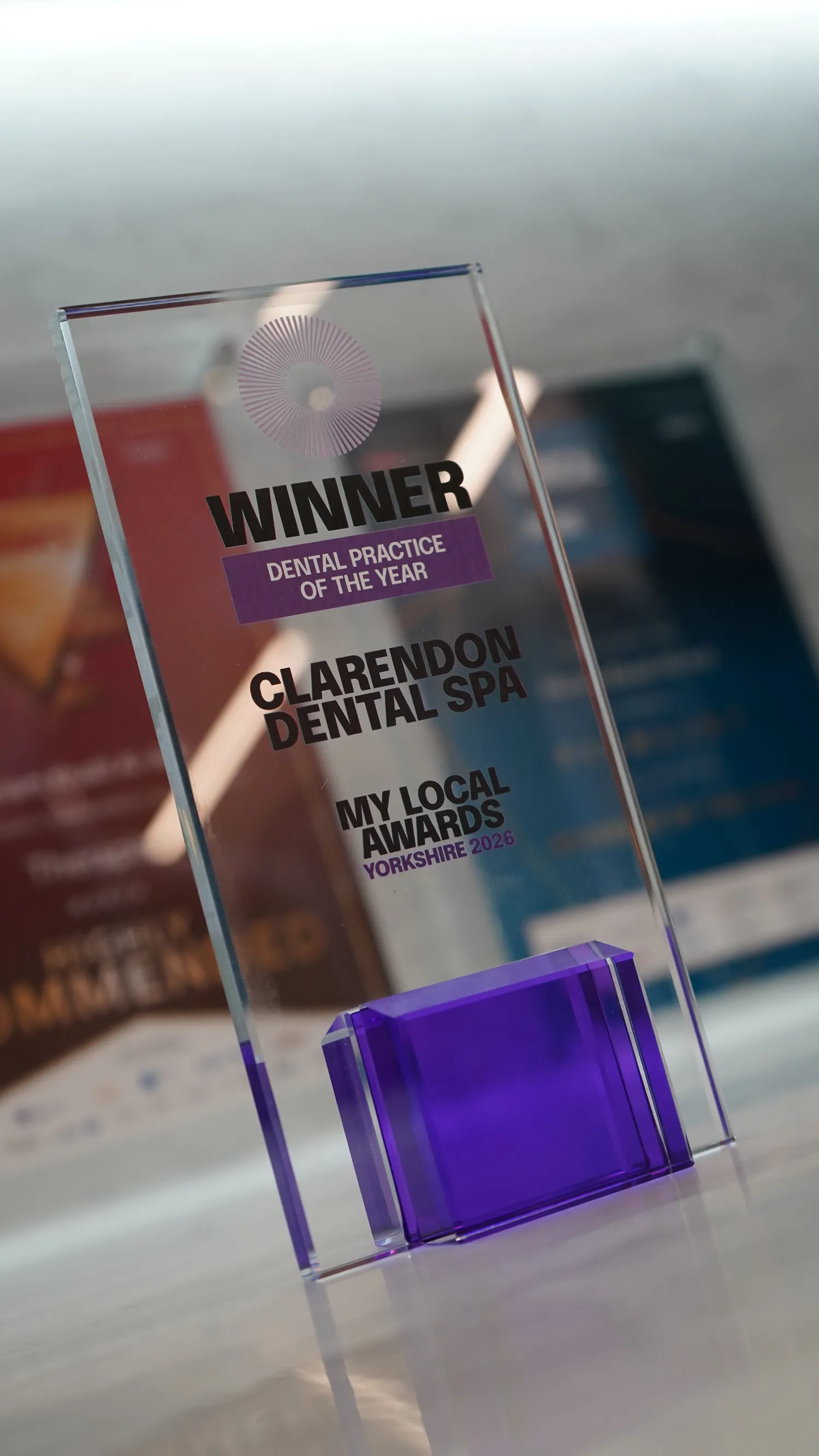 Clear glass award with a purple base reading Winner Dental Practice of the Year, Clarendon Dental Spa, My Local Awards Yorkshire 2026.