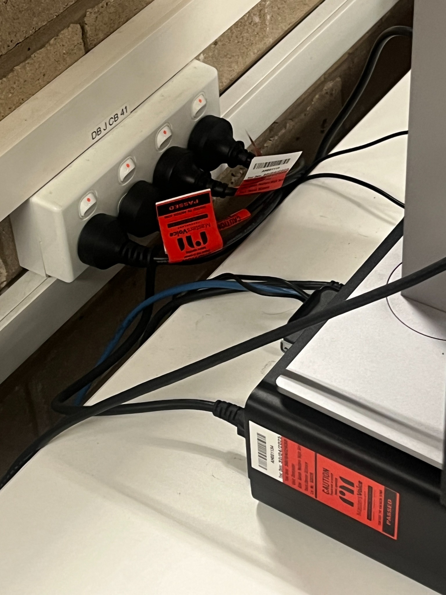 Masters Voice test labels on equipment and power leads.