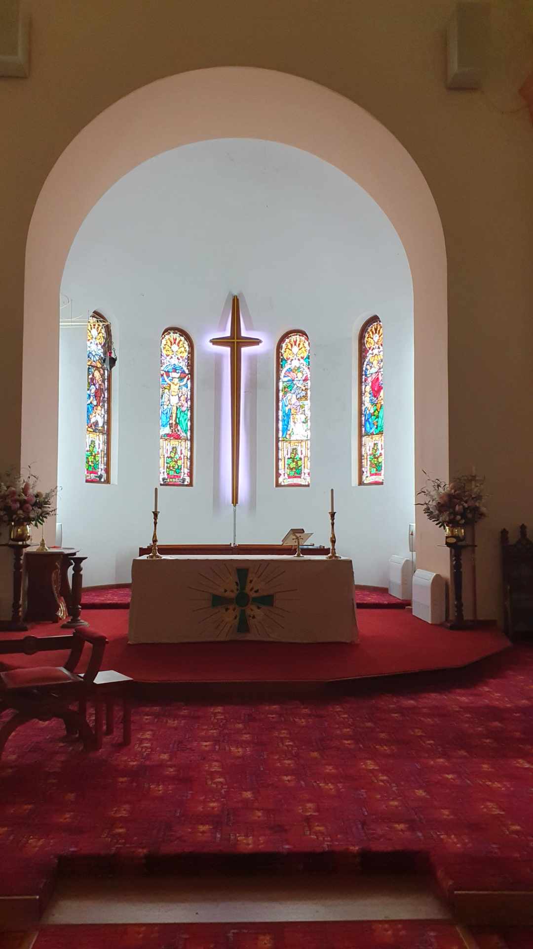 White lighting on the sanctuary and illuminated holy cross at St John’s Taree