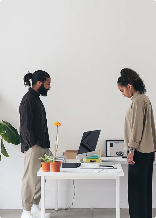 Launchist team members meeting and working together at a desk 