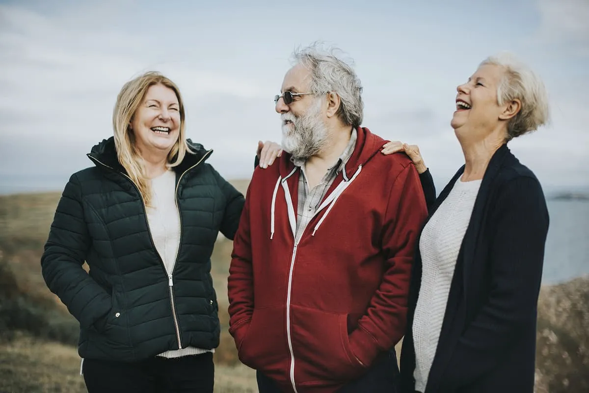 Mature friends laughing together outside