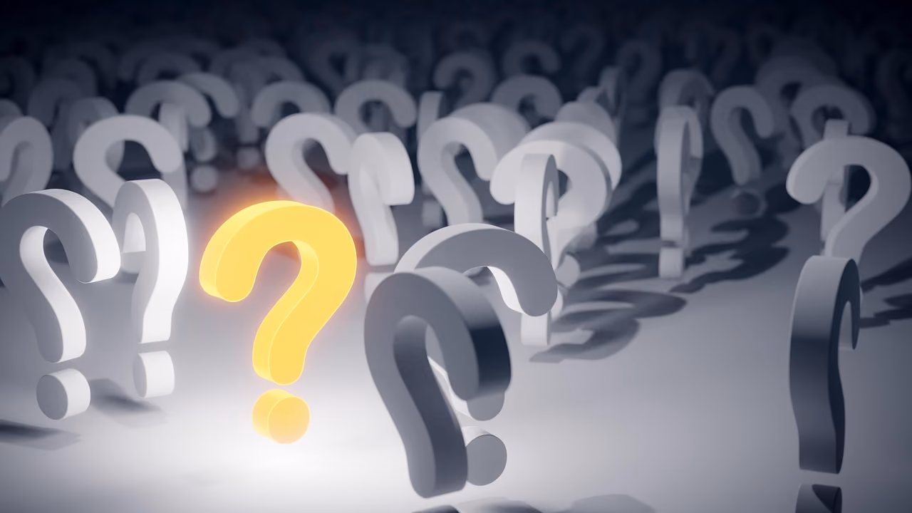 Multiple gray question marks with one glowing yellow question mark standing out in the center.