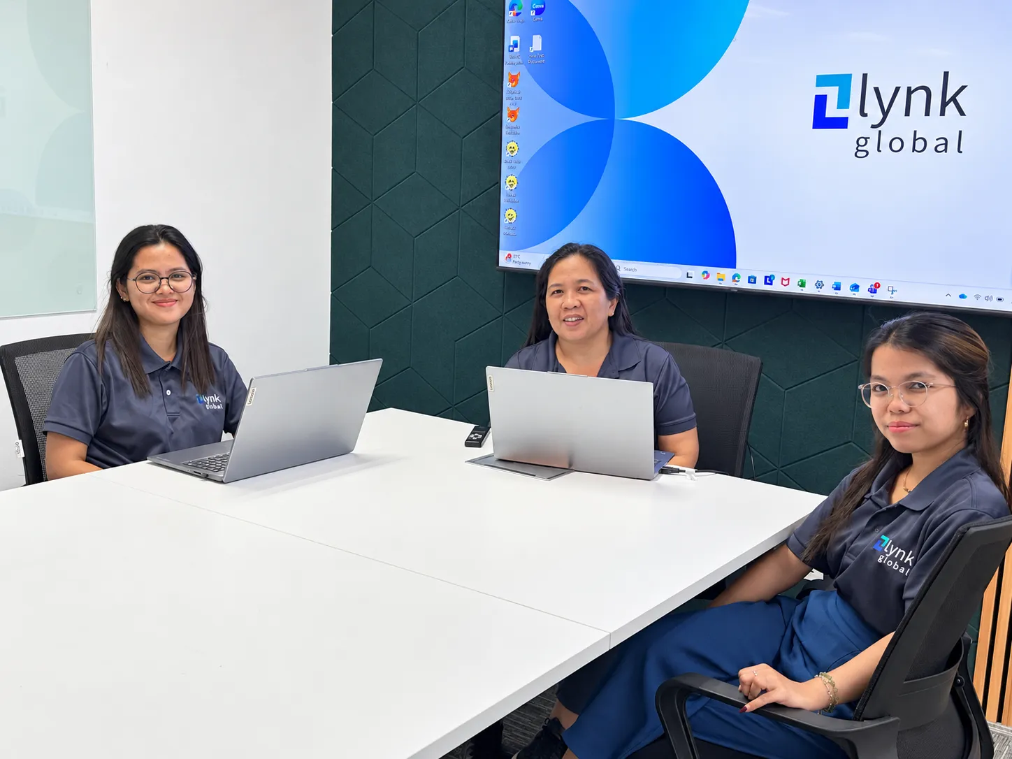 Lynk colleagues with laptops in the Manila meeting room