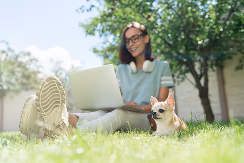 Young,Student,Girl,Sitting,Outdoors,On,The,Grass,Lawn,With